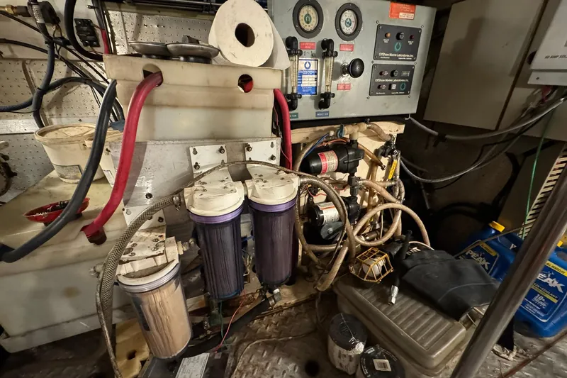 Slide: The Image of Engine room of a 1991 DeFever 44 boat with filters and control panels. - 79