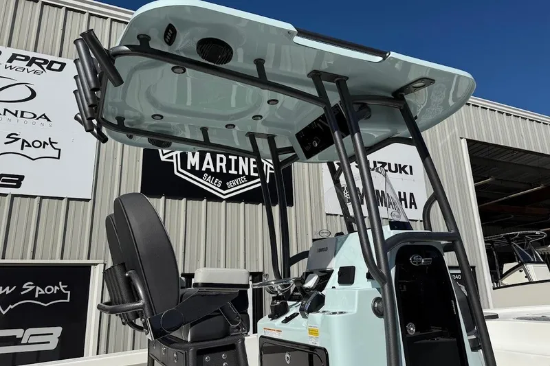 Slide: The Image of 2026 Sea Pro 250 Bay boat with T-top, displayed at a marine dealership. - 10