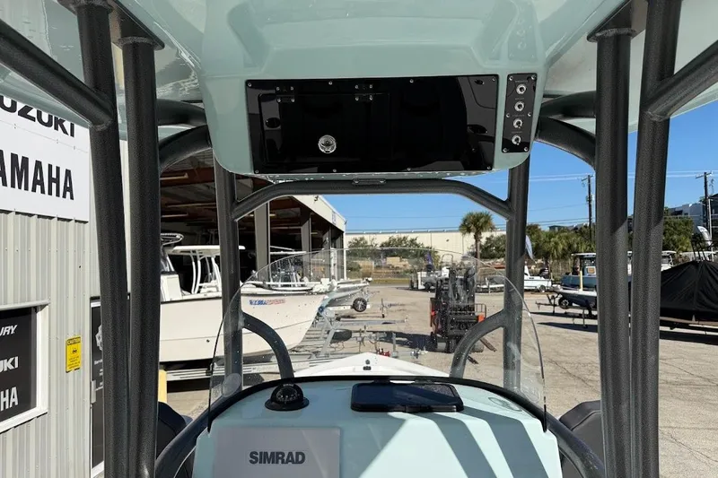 Slide: The Image of 2026 Sea Pro 250 Bay boat interior with Simrad electronics at a dealership. - 14