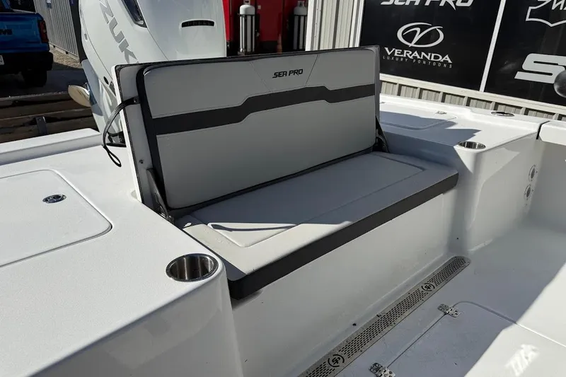 Slide: The Image of 2026 Sea Pro 250 Bay boat interior with seating and cup holders. - 16