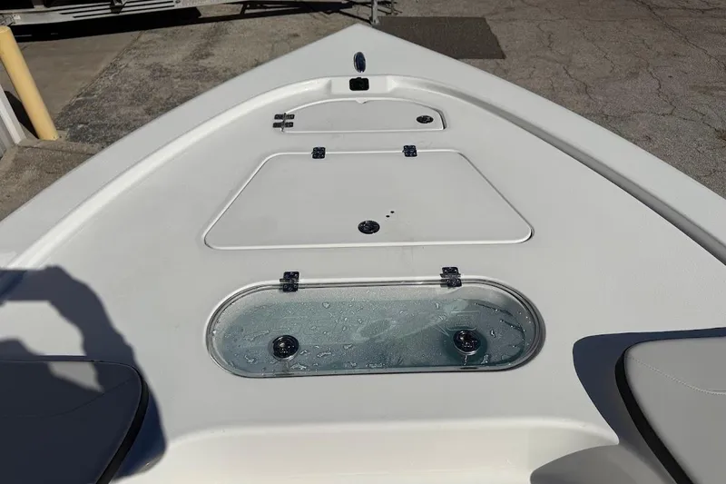 Slide: The Image of 2026 Sea Pro 250 Bay boat deck with storage compartments and livewell. - 19