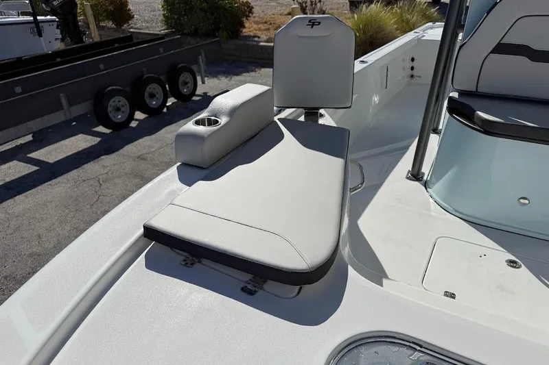 Slide: The Image of 2026 Sea Pro 250 Bay boat interior with cushioned seating and cup holder. - 21