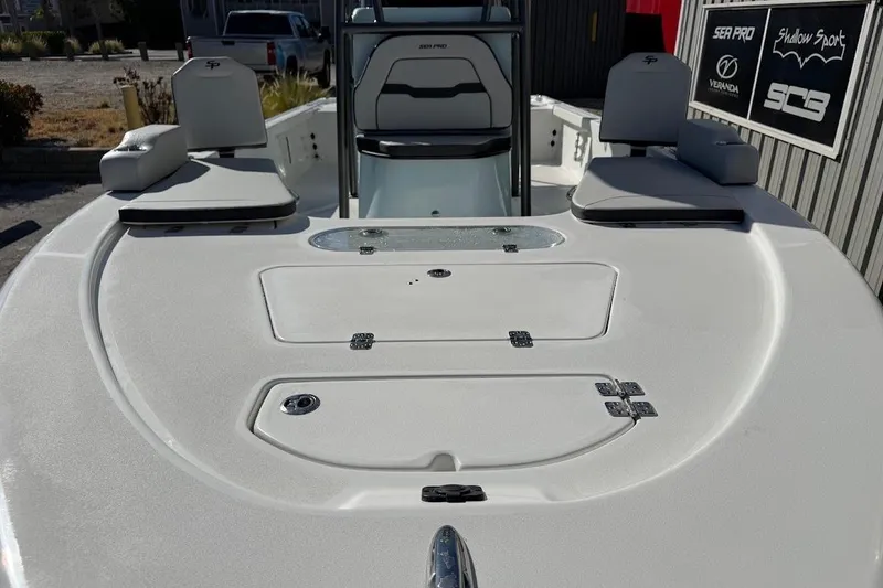 Slide: The Image of 2026 Sea Pro 250 Bay boat deck with seating and storage compartments. - 4