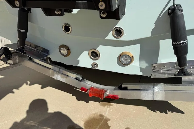 Slide: The Image of Rear view of 2026 Sea Pro 250 Bay boat with hydraulic components and trailer. - 8