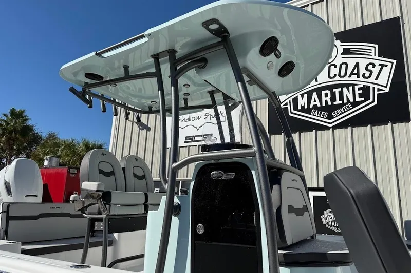 Slide: The Image of 2026 Sea Pro 250 Bay boat at West Coast Marine dealership, featuring modern seating and T-top. - 9