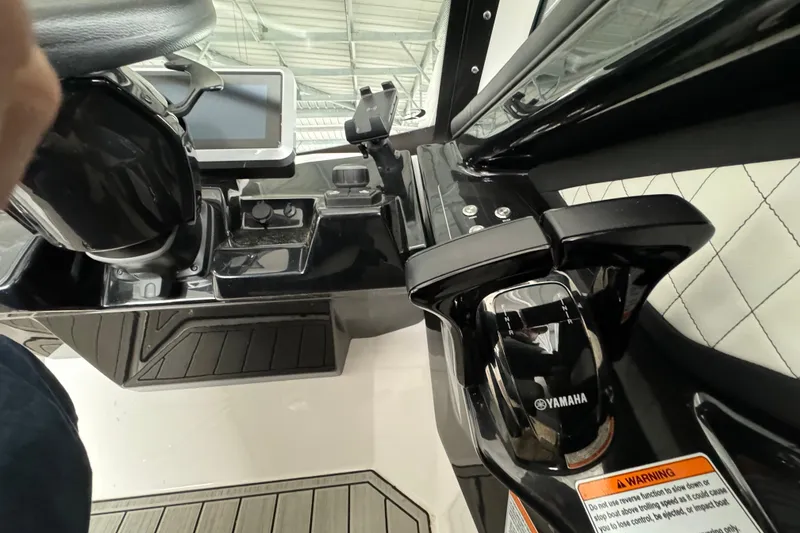 Slide: The Image of 2024 Yamaha Boats 275SD helm with steering wheel and control panel. - 12