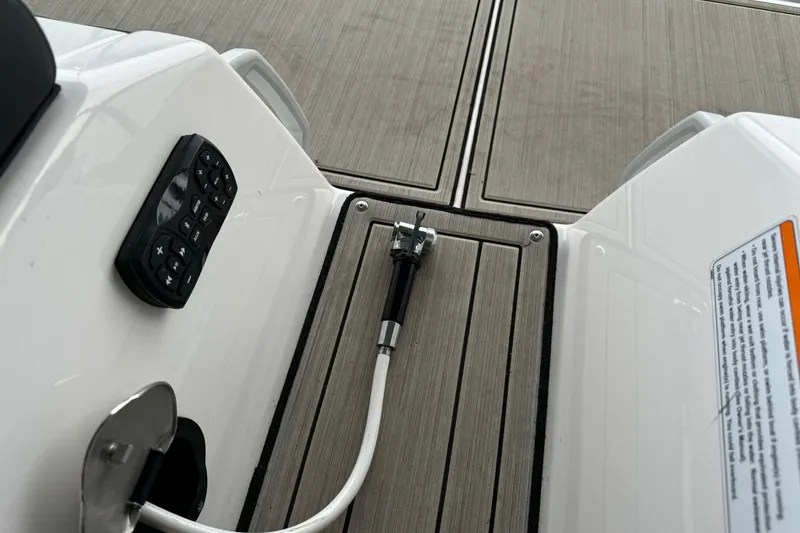 Slide: The Image of 2024 Yamaha Boats 275SD deck with control panel and hose attachment. - 18