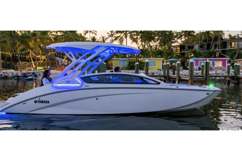 Slide: The Image of Manufacturer Provided Image: 2024 Yamaha Boats 275SD cruising at sunset with vibrant blue lights. - 2