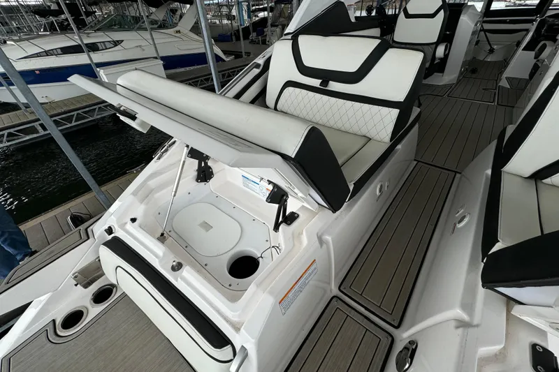 Slide: The Image of 2024 Yamaha Boats 275SD interior with open storage compartment and sleek seating design. - 20