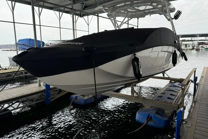 Slide: The Image of 2024 Yamaha Boats 275SD docked, covered, and elevated at marina. - 9