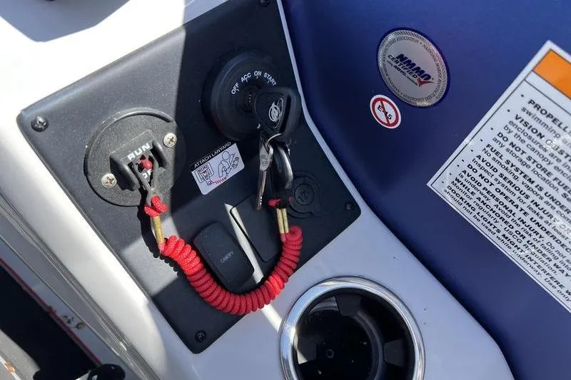 Slide: The Image of Control panel of 2023 Barletta Corsa 23Q boat with ignition key and safety lanyard. - 13