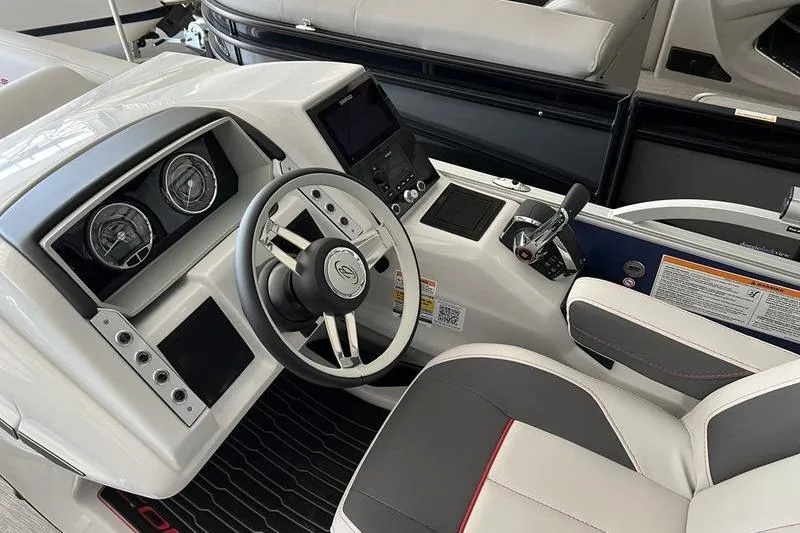 Slide: The Image of 2023 Barletta Corsa 23Q boat cockpit with modern steering and controls. - 14