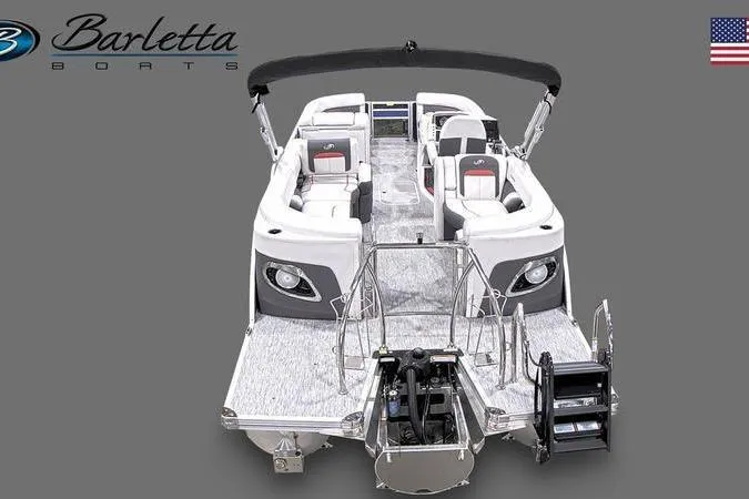 Slide: The Image of 2023 Barletta Corsa 23Q pontoon boat, sleek design, spacious seating, gray background, American flag. - 23