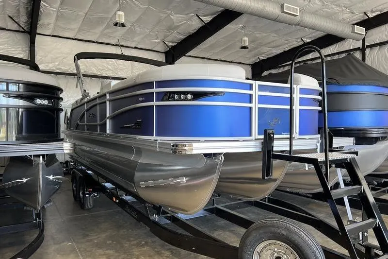 Slide: The Image of 2023 Barletta Corsa 23Q pontoon boat in showroom, featuring sleek blue design. - 25
