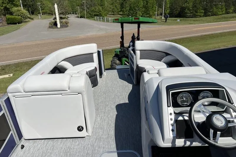 Slide: The Image of 2023 Barletta Corsa 23Q pontoon boat interior with plush seating and modern dashboard. - 7