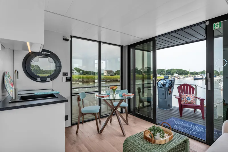 Slide: The Image of Modern Waterlodge Apart M 2024 interior with kitchen, dining area, and marina view. - 12