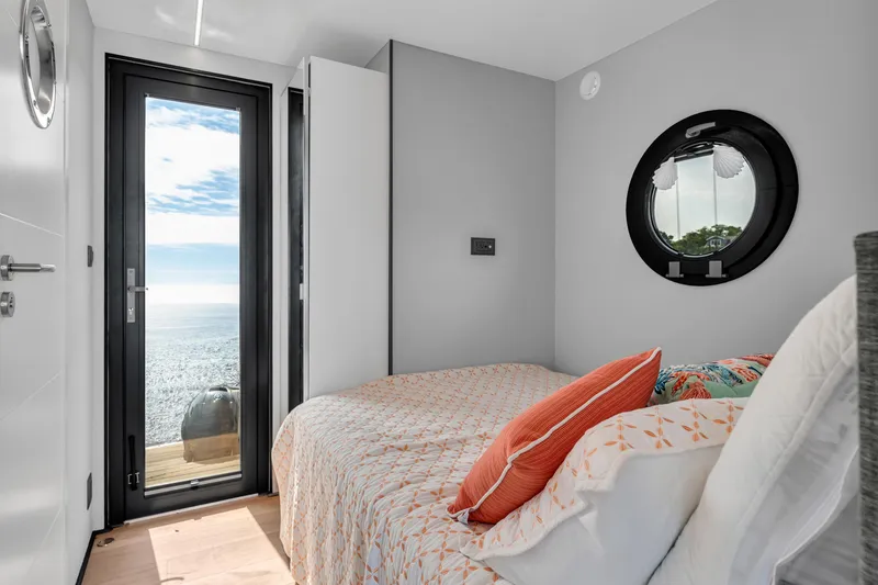Slide: The Image of Cozy bedroom in 2024 Waterlodge Apart M with ocean view and modern decor. - 14