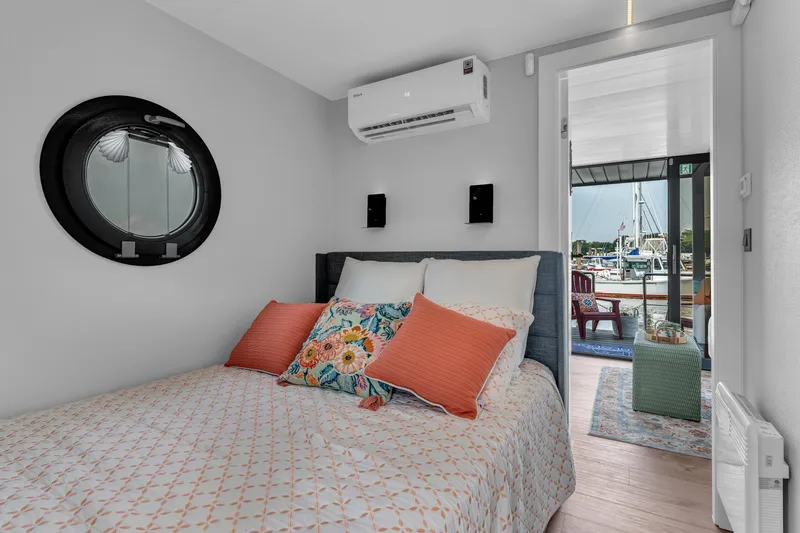 Slide: The Image of Cozy bedroom in 2024 Waterlodge Apart M with marina view and modern decor. - 16