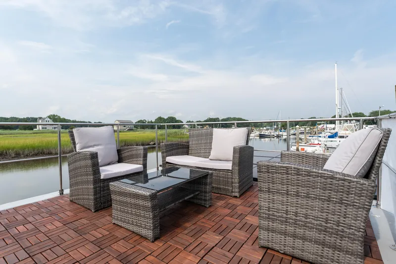 Slide: The Image of Rooftop deck of 2024 Waterlodge Apart M with wicker furniture and marina view. - 24