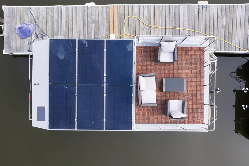 Slide: The Image of Aerial view of 2024 Waterlodge Apart M houseboat with solar panels and outdoor seating. - 8