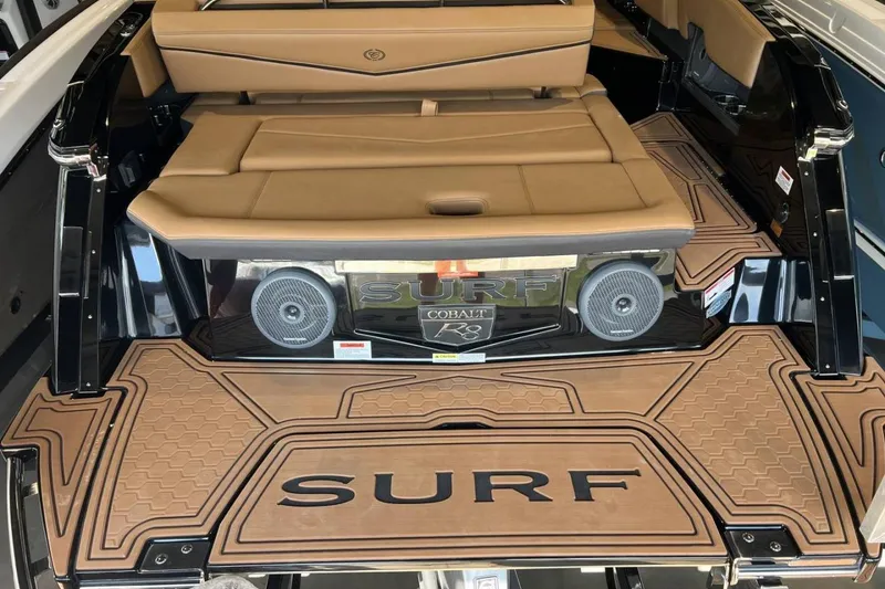 Slide: The Image of 2026 Cobalt R8 Surf boat interior with tan seating and custom flooring. - 12