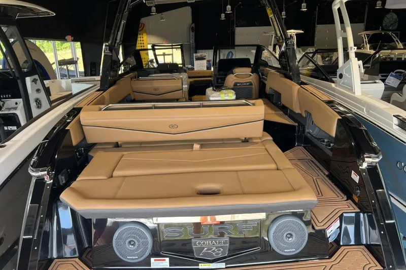 Slide: The Image of 2026 Cobalt R8 Surf boat interior with tan leather seating and modern design. - 13
