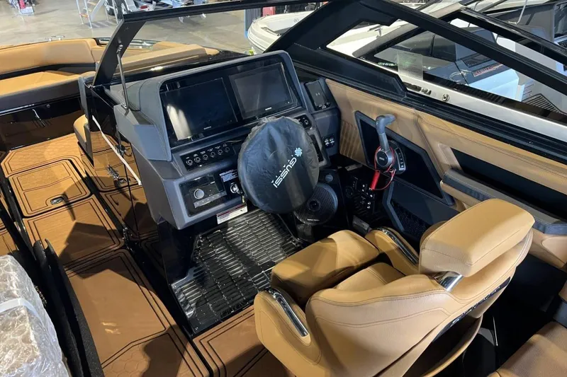 Slide: The Image of Interior of 2026 Cobalt R8 Surf boat with modern dashboard and tan seating. - 18