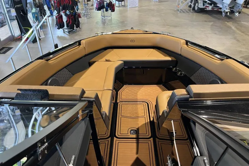 Slide: The Image of 2026 Cobalt R8 Surf boat interior with tan seating and stylish flooring in showroom. - 23