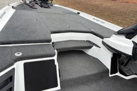 Slide: The Image of 2023 Skeeter ZXR20 boat deck with gray carpeting and storage compartments. - 10