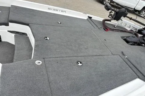 Slide: The Image of 2023 Skeeter ZXR20 boat deck with gray carpeting and storage compartments. - 12