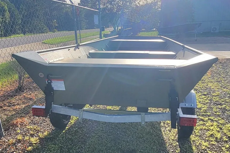 Slide: The Image of 2026 Lowe L1648 Jon boat on trailer, parked outdoors in sunlight. - 6