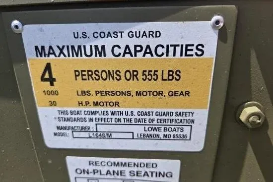 Slide: The Image of U.S. Coast Guard capacity label for 2026 Lowe L1648 Jon boat, 4 persons or 555 lbs. - 7
