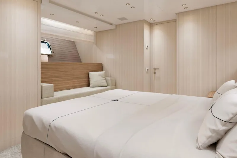 Slide: The Image of Luxurious 2025 Sanlorenzo SX88 yacht bedroom with modern design and cozy seating area. - 15