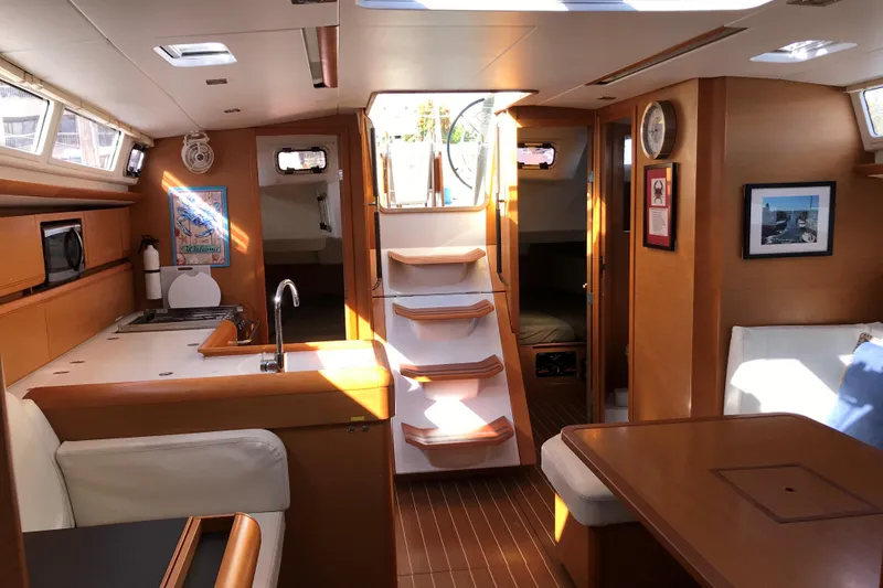 Slide: The Image of Interior of 2015 Jeanneau Sun Odyssey 469 sailboat, featuring kitchen and seating area. - 13