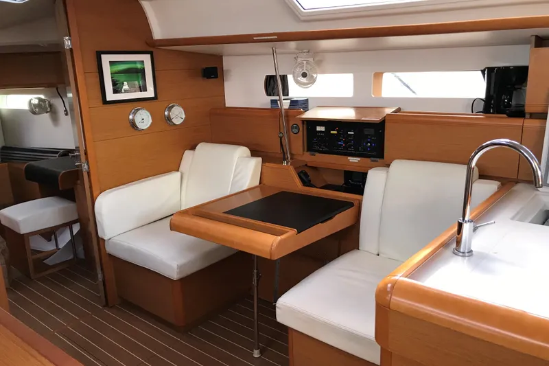 Slide: The Image of Interior of 2015 Jeanneau Sun Odyssey 469 yacht with modern seating and navigation panel. - 14