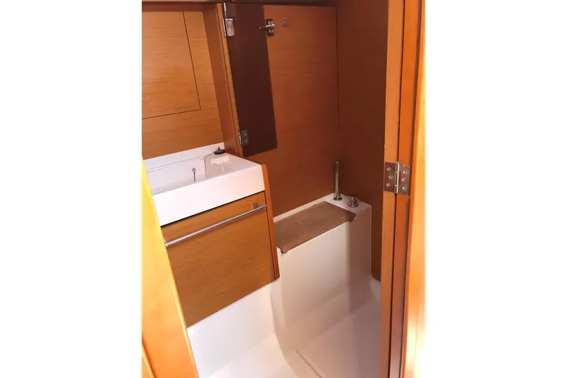 Slide: The Image of 2015 Jeanneau Sun Odyssey 469 bathroom interior with wooden cabinetry and compact sink. - 18