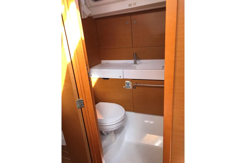 Slide: The Image of Interior of 2015 Jeanneau Sun Odyssey 469 yacht bathroom with wooden cabinetry and modern fixtures. - 19
