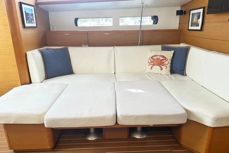 Slide: The Image of Interior of 2015 Jeanneau Sun Odyssey 469 yacht with white seating and nautical decor. - 21