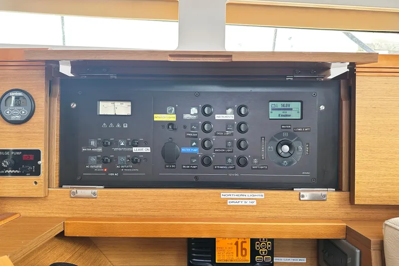 Slide: The Image of Control panel of 2015 Jeanneau Sun Odyssey 469 yacht, featuring various switches and gauges. - 27