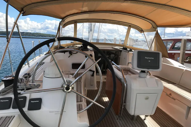 Slide: The Image of 2015 Jeanneau Sun Odyssey 469 yacht cockpit with steering wheel and navigation equipment. - 3
