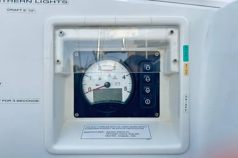 Slide: The Image of Control panel of a 2015 Jeanneau Sun Odyssey 469 sailboat, featuring a Yanmar RPM gauge. - 32