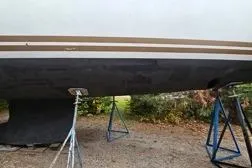 Slide: The Image of 2015 Jeanneau Sun Odyssey 469 sailboat on stands, hull view. - 40