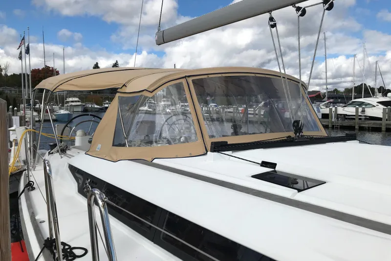 Slide: The Image of 2015 Jeanneau Sun Odyssey 469 sailboat docked at marina under cloudy sky. - 6