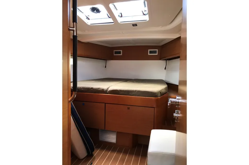 Slide: The Image of Interior cabin of 2015 Jeanneau Sun Odyssey 469 sailboat, featuring a cozy bed and wooden finish. - 8