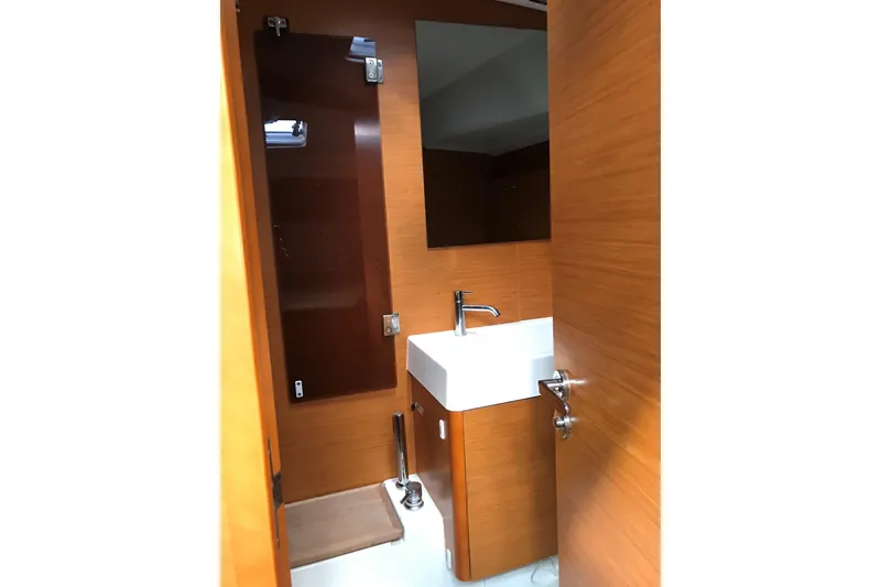 Slide: The Image of Bathroom interior of 2015 Jeanneau Sun Odyssey 469 yacht with wooden finish and modern sink. - 9