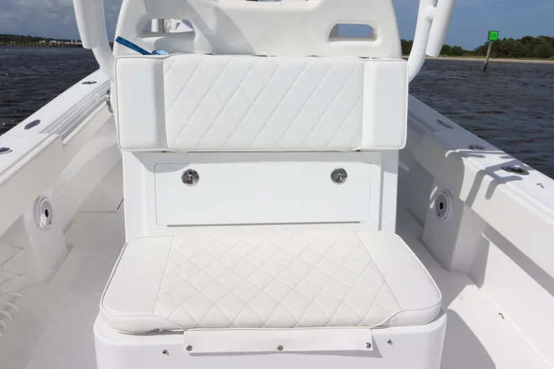 Slide: The Image of 2022 Onslow Bay 33 boat interior with white cushioned seating. - 10