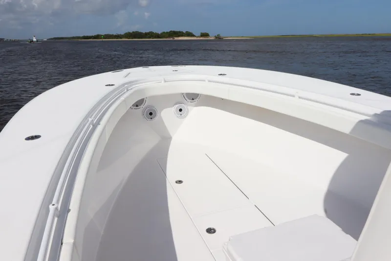 Slide: The Image of 2022 Onslow Bay 33 boat, spacious deck, calm waters, clear sky. - 11