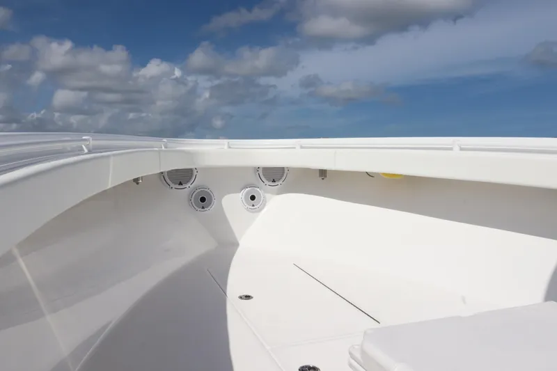 Slide: The Image of 2022 Onslow Bay 33 boat interior with speakers under a clear blue sky. - 12