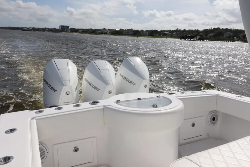 Slide: The Image of 2022 Onslow Bay 33 boat with triple Mercury engines on a sunny day. - 8