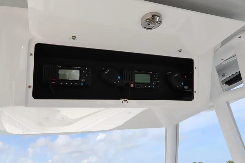 Slide: The Image of 2022 Onslow Bay 33 boat console with communication equipment and clear sky background. - 9
